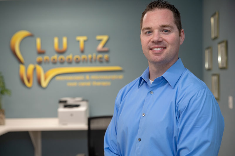 A man standing in front of a sign.